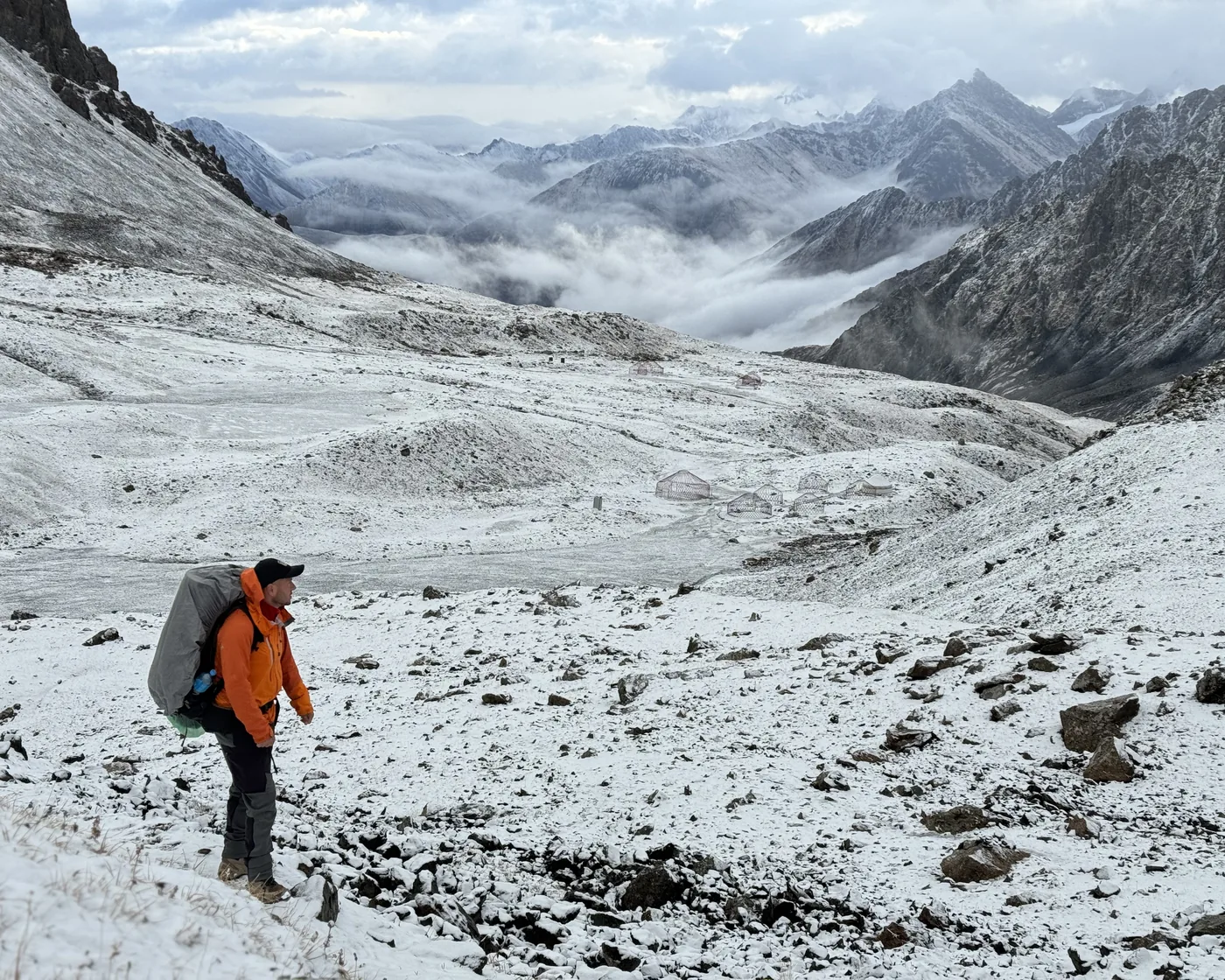 Hiking a snowy Caucasus pass at first snowfall